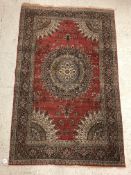 A pair of fine Oriental rugs, the central panel set with floral decorated circular medallion on a