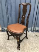 A set of five walnut framed dining chairs in the early 18th Century manner, the shaped backs with