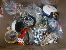 A box containing a large quantity of various mixed costume jewellery, jewellery boxes, dome top