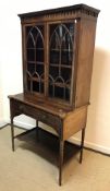 A 19th Century mahogany and inlaid secretaire bookcase, the upper section with decorative cornice