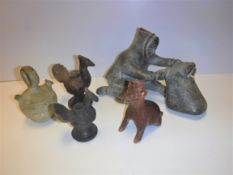 A collection of various pre-Colombian style pottery including a red slip bottle as a cat or dog with