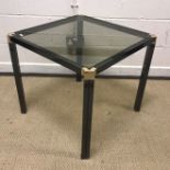 A modern coffee table, the circular glass top raised on a cast metal tripod base, 90 cm diameter x