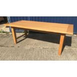 A modern Conran oak dining table, the plain top with cleated effect ends, raised on square supports,
