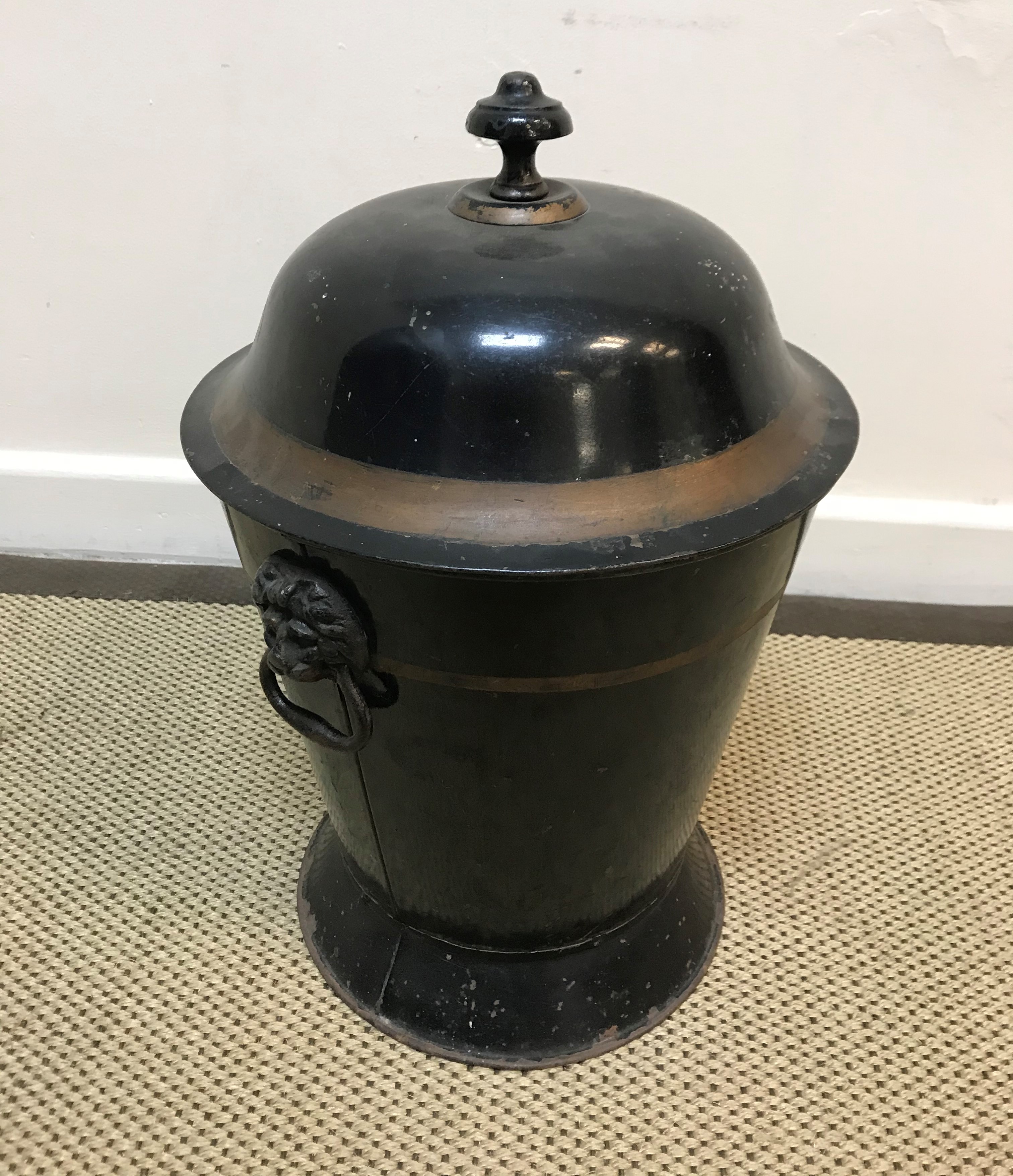 A 19th Century toleware coal box, black painted and gilt banded, the domed top with mushroom finial,