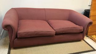 A modern upholstered scroll arm Chesterfield style sofa in red herringbone upholstery on squat