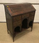 A circa 1900 "Medina" Arts & Crafts oak bureau, the sloping fall with moulded decoration opening