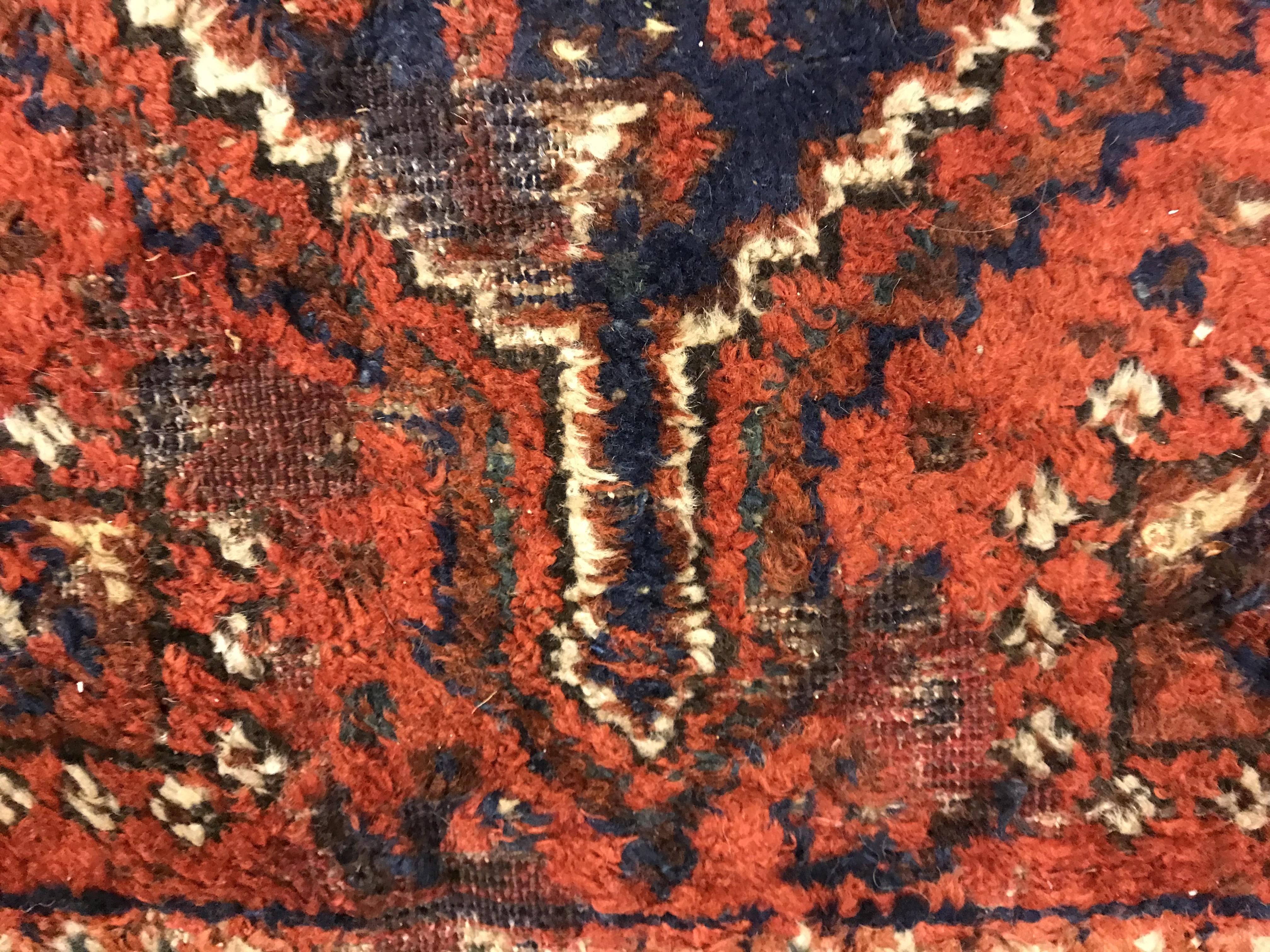 A Shiraz carpet, the central panel set with three joined diamond shaped medallions on a red and blue - Image 13 of 17