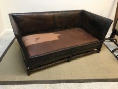 A Victorian studded leather upholstered sofa in the 17th Century manner, raised on turned and
