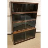 A Minty mahogany cased four section bookcase with sliding glass doors bearing label "Minty Limited