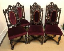 A set of six carved oak Carolean style dining chairs with all-over foliate and floral carved