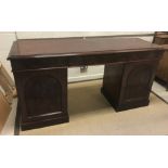 A Victorian mahogany sideboard, the plain top with moulded edge above three frieze drawers, raised