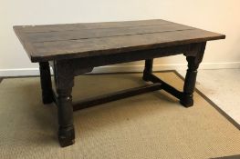 An oak refectory table in the 17th Century manner, the three plank top with cleated ends above a