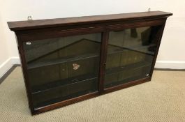 A circa 1900 mahogany hanging wall display cabinet with two plain glazed doors enclosing four