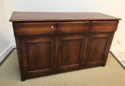 A modern cherry wood sideboard in the 19th Century Continental manner, the plain top with moulded