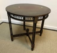 An Edwardian mahogany circular centre table on cluster column supports united by fretwork carved