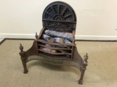 A 20th Century steel and cast iron fire basket in the Regency taste with integral fan decorated back