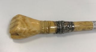 A Victorian carved ivory and bone conductor's baton, the handle as a clenched fist with embossed