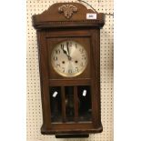 A mid 20th Century walnut cased drop dial wall clock, the eight day movement with silvered dial