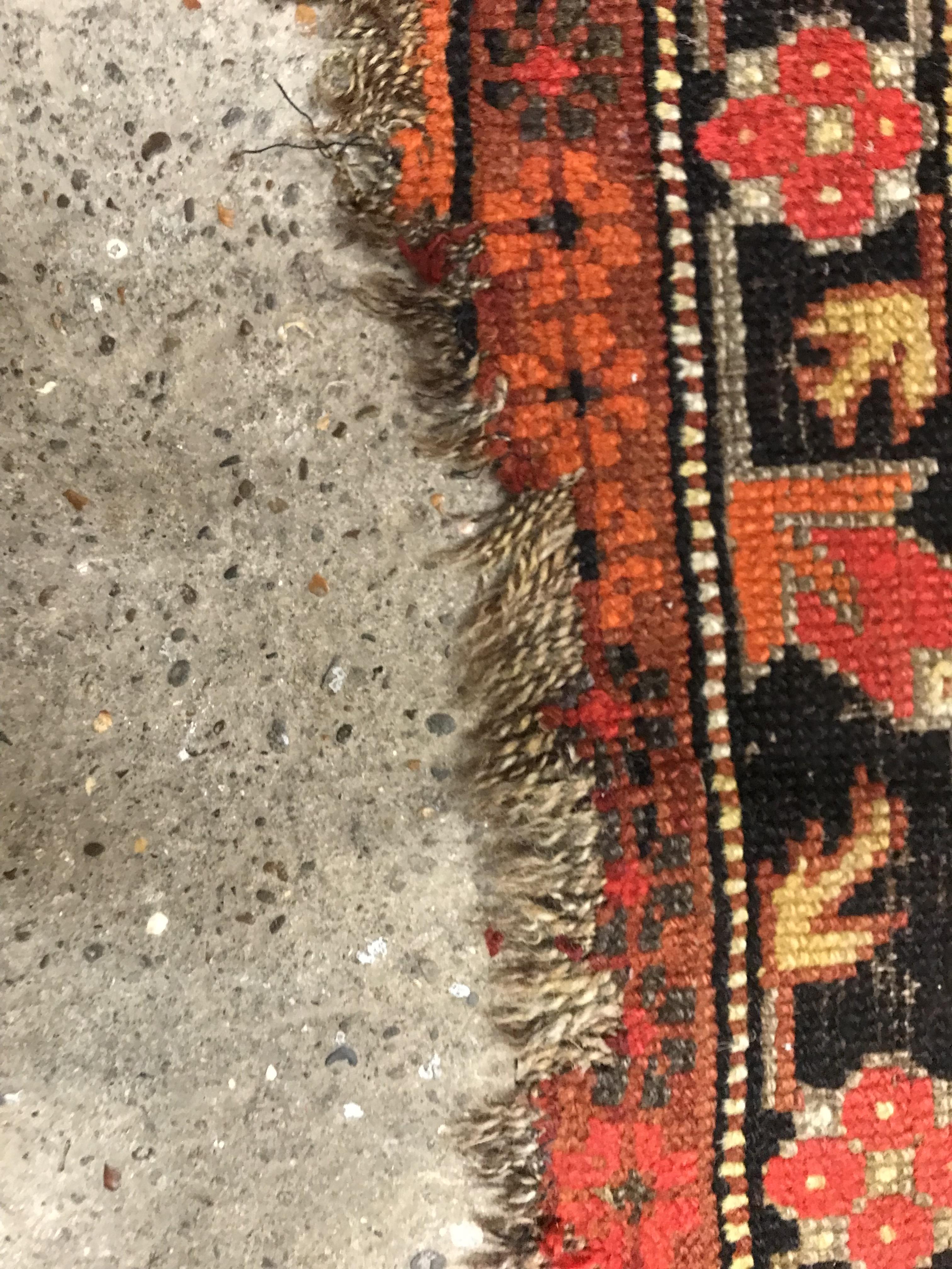 A Caucasian rug, the central panel set with three repeating medallions on a brown ground, within a - Image 5 of 10