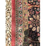 A Tabriz type carpet, the central panel set with foliate and bird decoration and central vase of