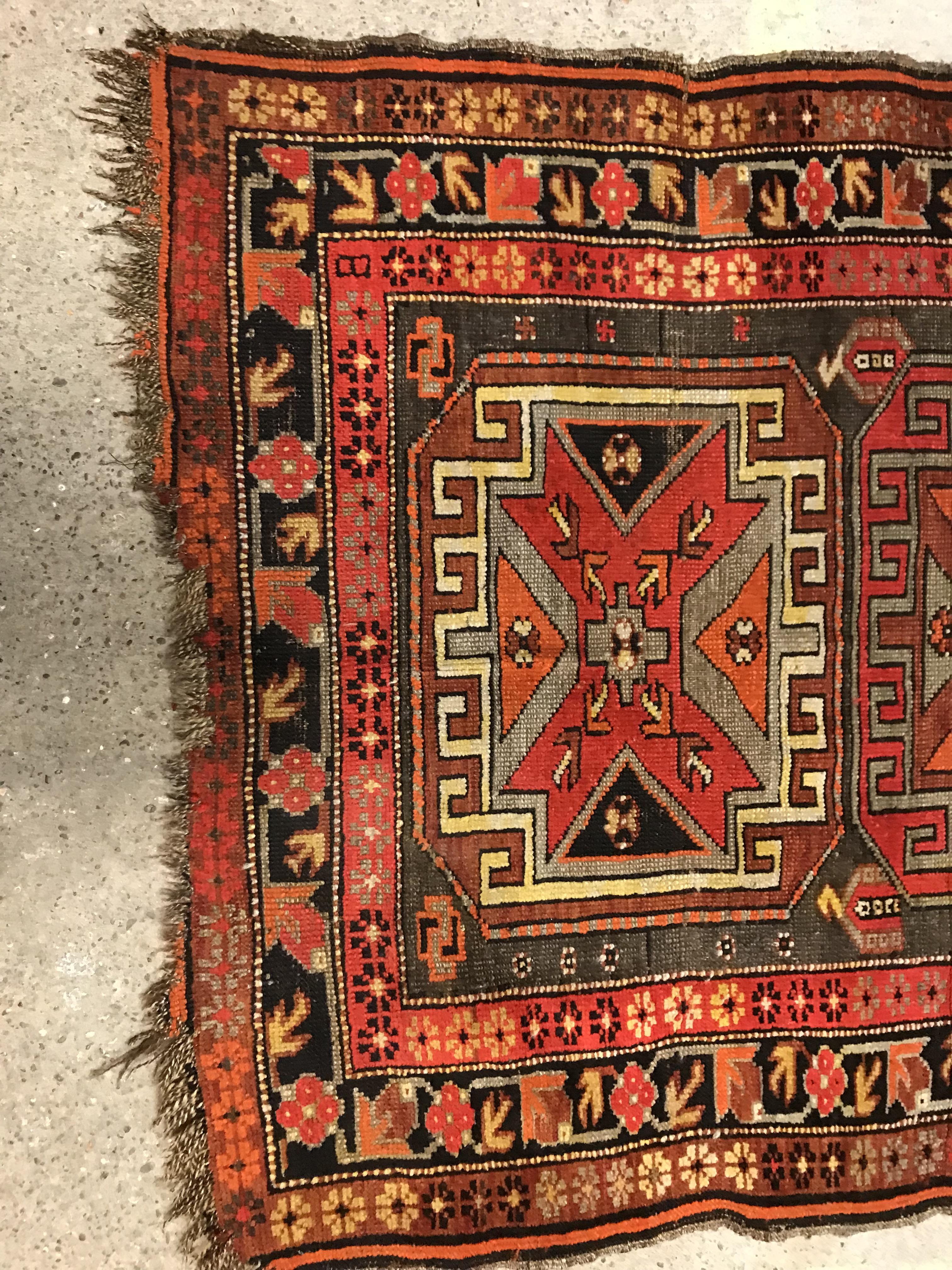 A Caucasian rug, the central panel set with three repeating medallions on a brown ground, within a - Image 2 of 10