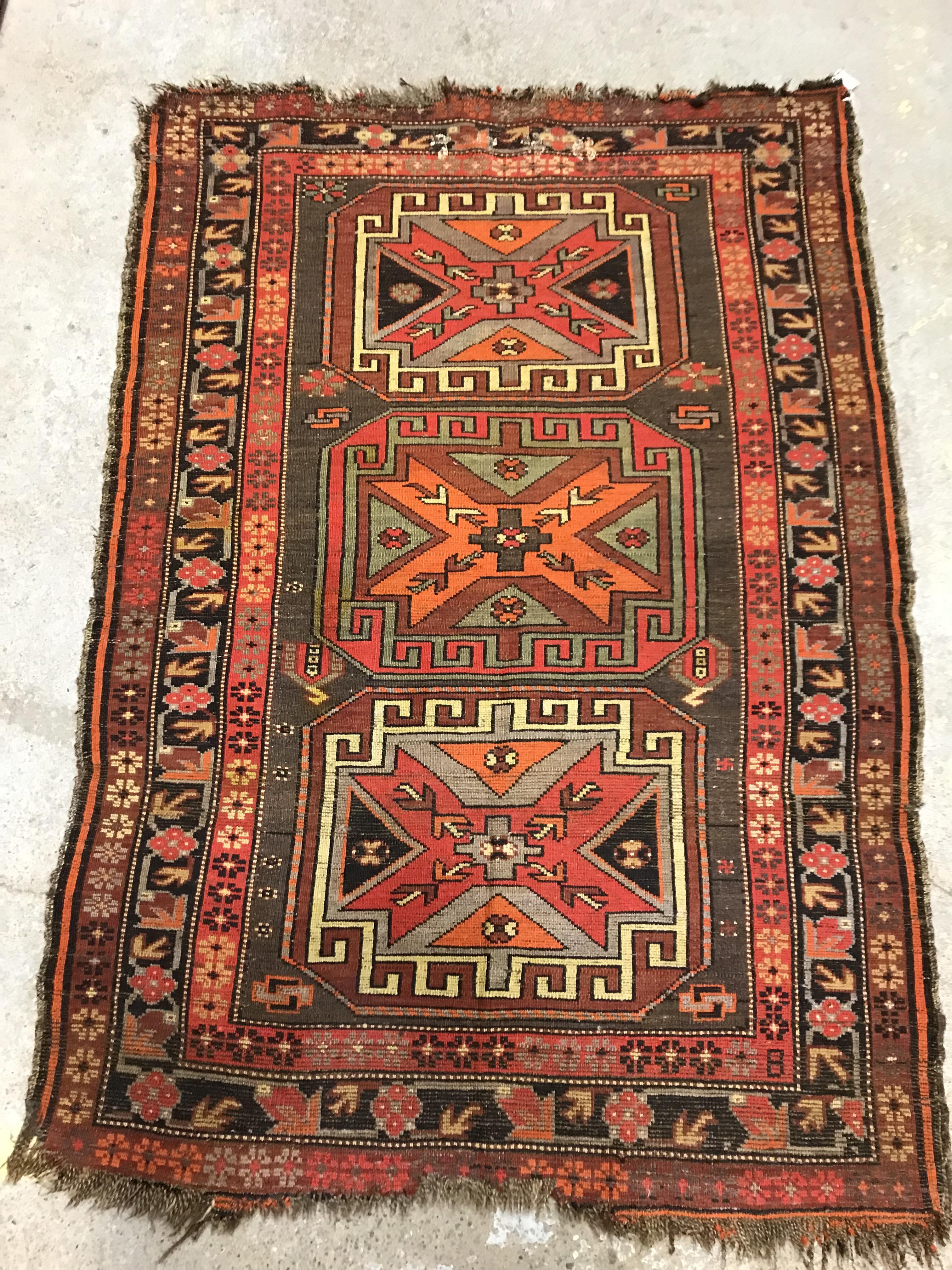 A Caucasian rug, the central panel set with three repeating medallions on a brown ground, within a - Image 9 of 10