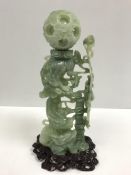 A 20th Century Chinese carved jade puzzle ball on three dragon stand, approx 36 cm high