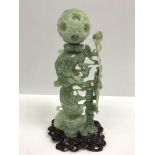 A 20th Century Chinese carved jade puzzle ball on three dragon stand, approx 36 cm high