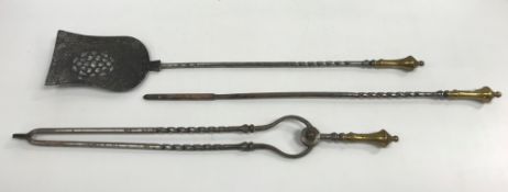 A set of three late 18th / early 19th Century brass-handled iron fireside tools of barley-twist