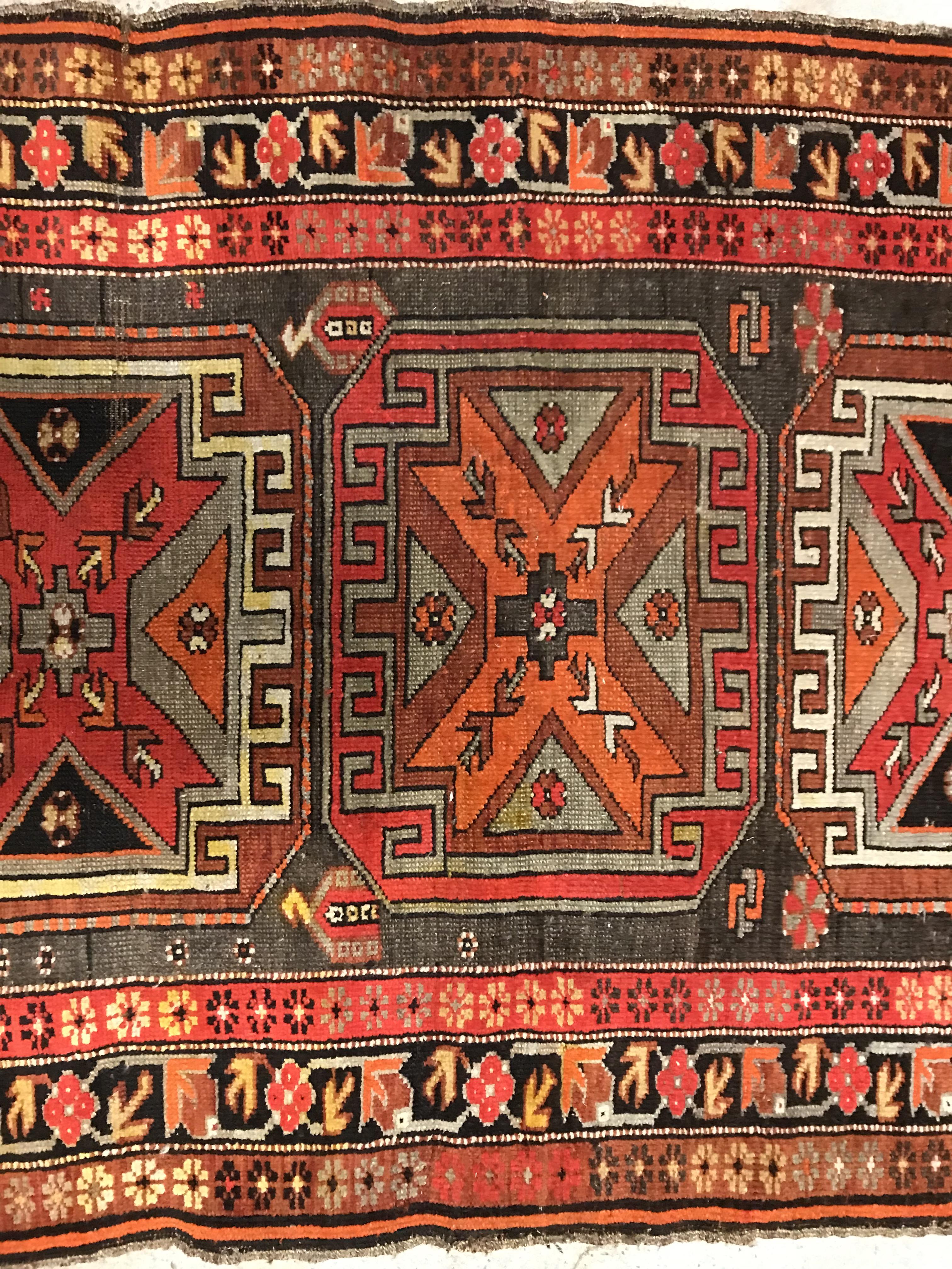 A Caucasian rug, the central panel set with three repeating medallions on a brown ground, within a - Image 3 of 10