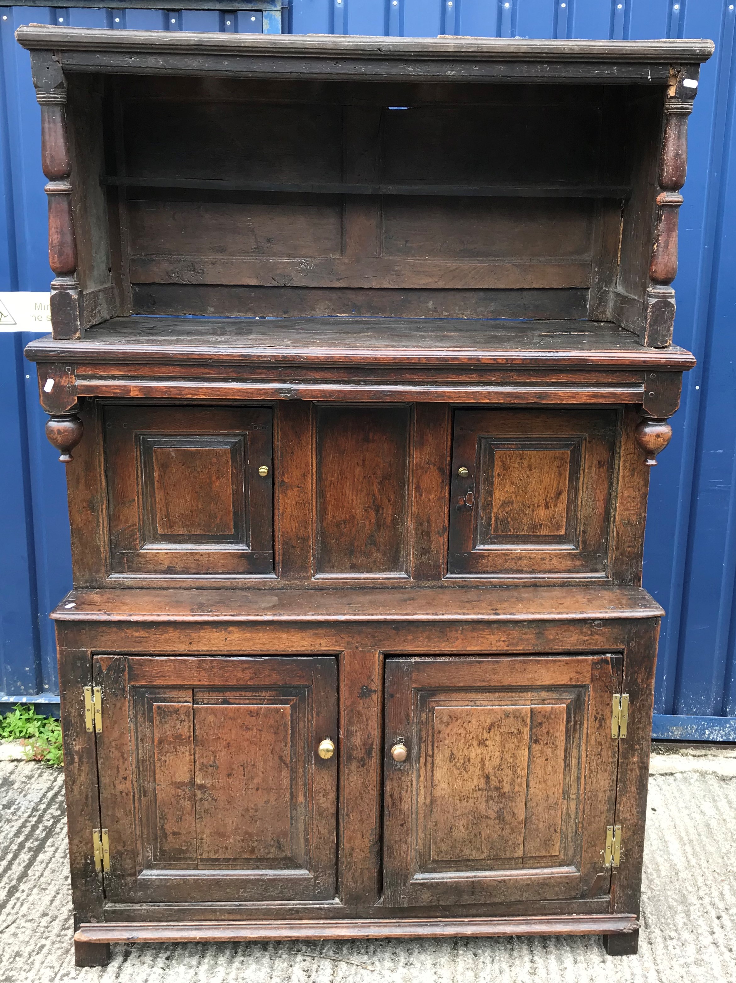 An 18th Century oak tridarn, the upper section with panelled sides and turned column supports over a