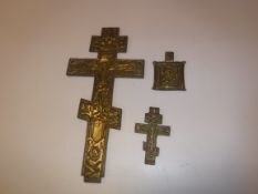 A 19th Century Russian brass reliquary cross depicting "Christ upon the cross", with various other