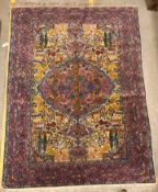 A mid 20th Century Tabriz rug, the central panel set with all-over animal and floral motifs on a