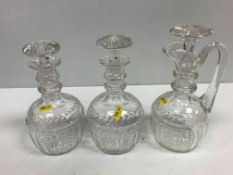 A pair of 19th Century facet and foliate cut mallet-shaped decanters with two ring neck and