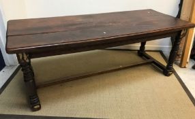 A modern mahogany refectory style dining table, the rectangular top on turned supports to block