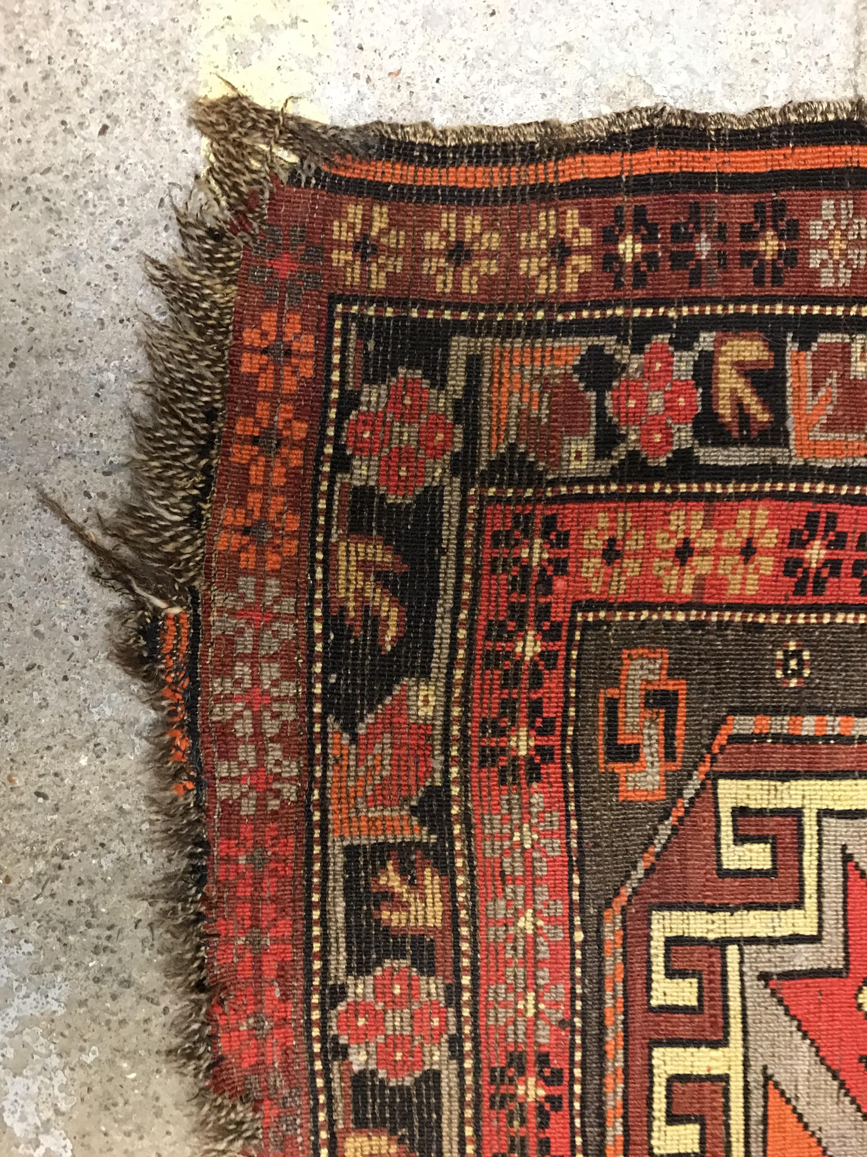 A Caucasian rug, the central panel set with three repeating medallions on a brown ground, within a - Image 10 of 10