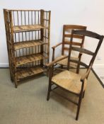 A Victorian stained beech rush seat ladder back elbow chair, 54 cm wide x 56 cm deep x 107 cm