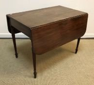 An early 19th Century mahogany drop-leaf Pembroke table on slender turned and reeded tapering legs