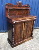 A Victorian rosewood chiffonier with raised shelved back on bobbin turned supports over a cushion