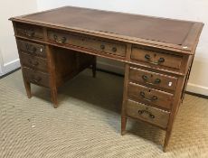 An early 20th Century mahogany double pedestal desk with three frieze drawers raised on two banks of