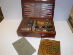 A mahogany cased games compendium containing various games pieces including Chess, Draughts,