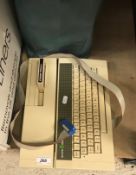 A vintage Acorn Electron computer and accessories to include games "Sphinx Adventure", "Starship