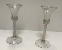 Two 19th Century air-twist stemmed trumpet-shaped wines on raised circular feet, 18.2 cm high