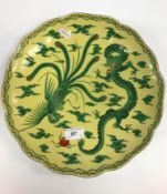 An early 20th Century Japanese Fukagawa famille verte / jaune plate, the main field decorated with a