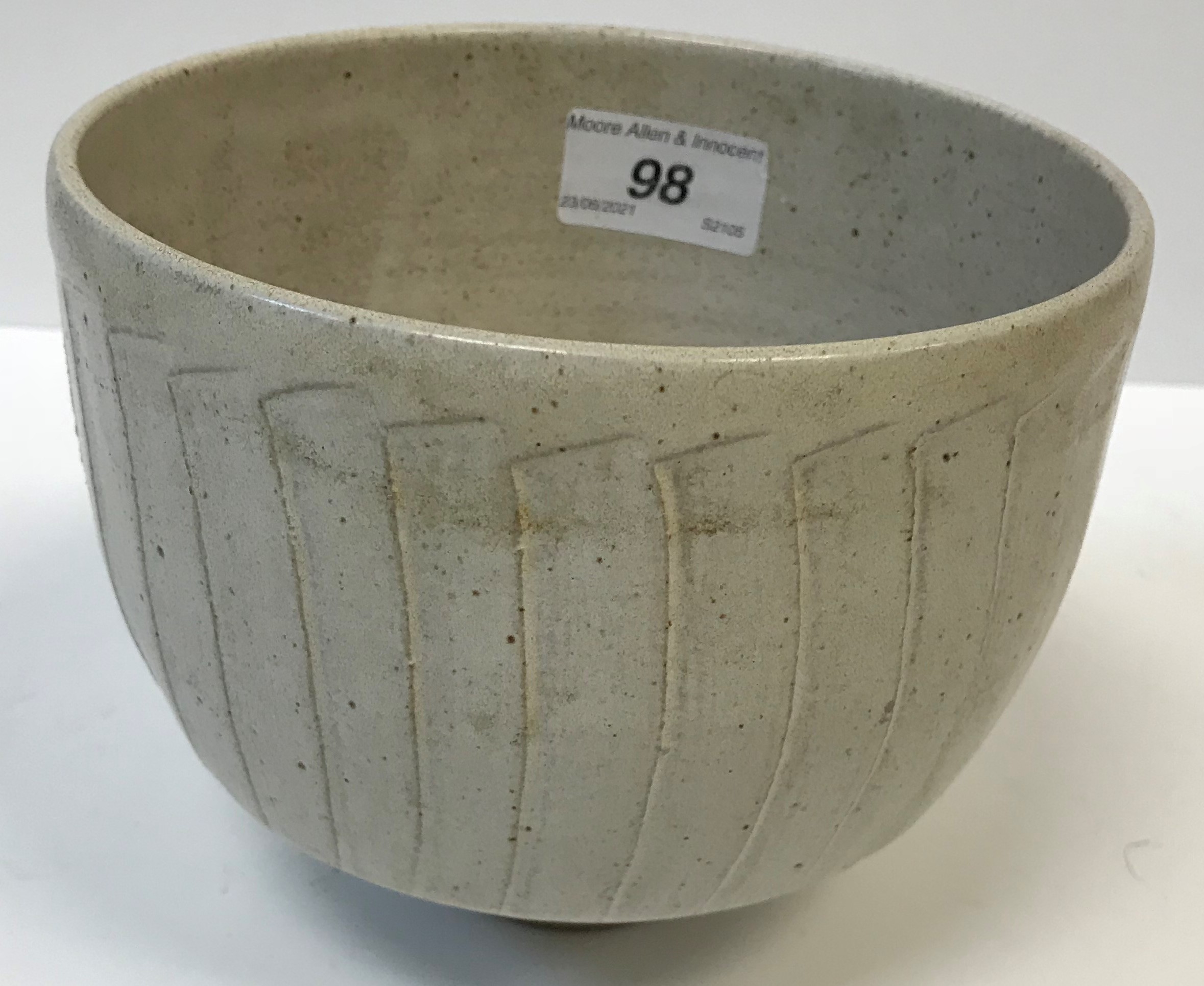 A David Leach cut sided vase in dolomite type glaze with unglazed circular foot, 12 cm high x 15