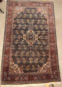 A Kashan carpet, the central panel set with floral decorated medallion on a dark blue hook decorated