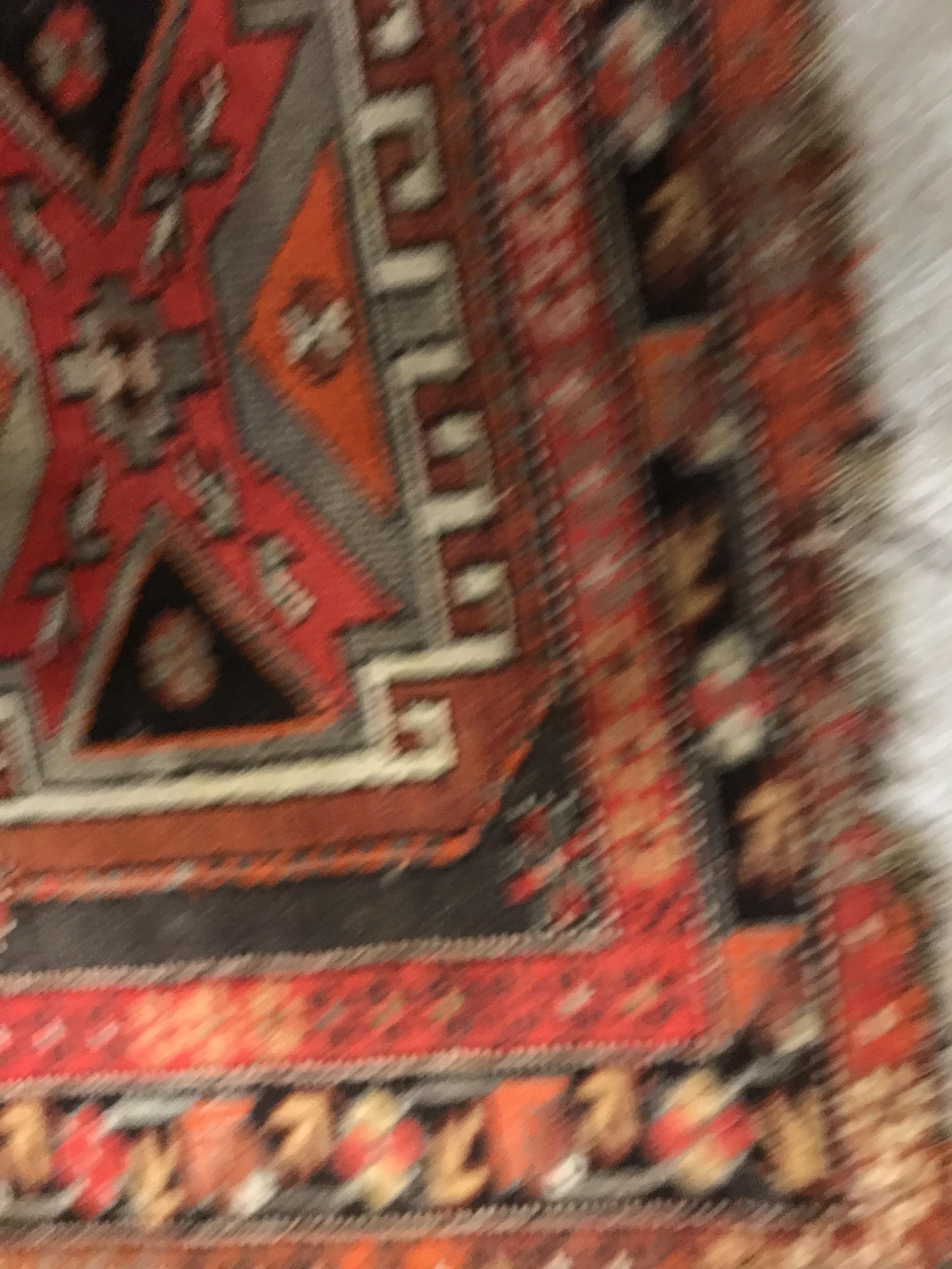A Caucasian rug, the central panel set with three repeating medallions on a brown ground, within a - Image 7 of 10