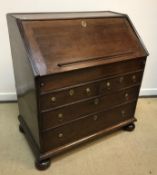 An 18th Century oak bureau, the plain top above a