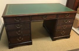 A modern mahogany double pedestal desk in the Geor