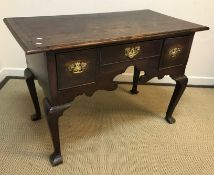 A 19th Century oak lowboy the plain top with mould